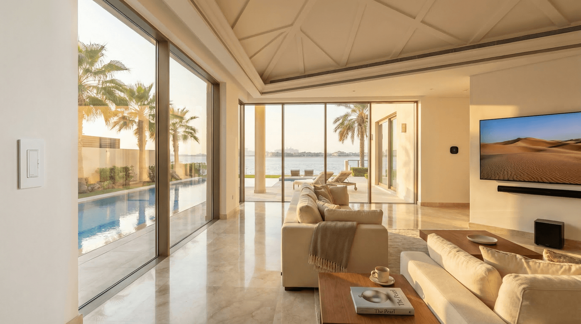 Spacious Palm Jumeirah villa living room with ocean views through floor-to-ceiling windows and smart home devices