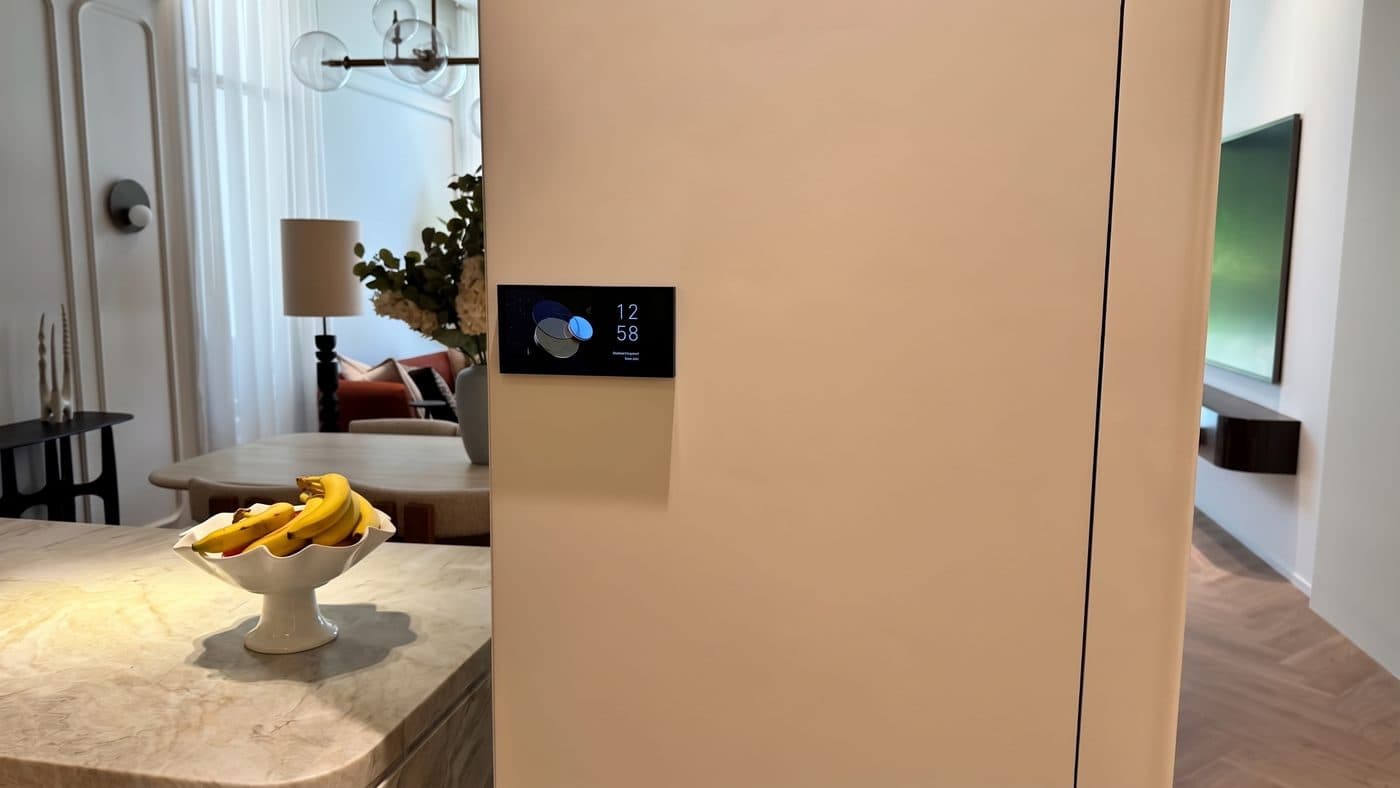 Aqara touch panel on a kitchen column in an Al Furjan villa, with the dining table and living room beyond