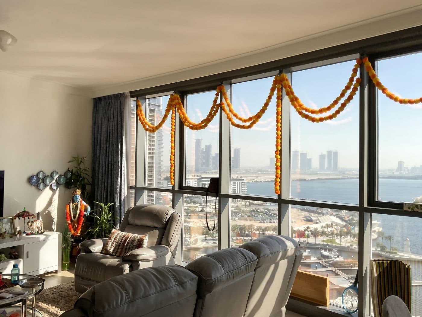 Living room of a Dubai Creek Harbour apartment with floor-to-ceiling windows over the creek and skyline